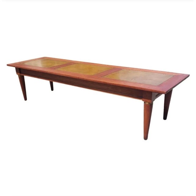 Beautiful long solid cherry with leather top coffee table , cocktail table in good condition. Measures 60 inches in width,...