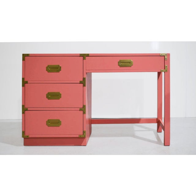 1970s Campaign desk by Bernhardt, newly painted in pink, with a rectangular top and four flush-front drawers. Three...
