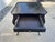 Black pavilion side table with drawer. Japanned finish with cabriole legs and scalloped top. There are gold floral designs...