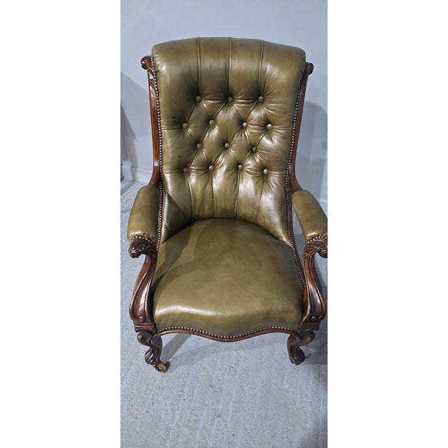A superb quality Regency rosewood deep buttoned library chair covered in olive green leather and brass studded, original...