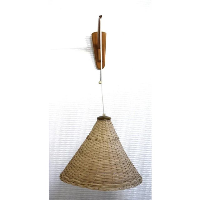 Scandinavian wall lamp from around 1970. Wicker umbrella. Up to 250V (Europe/UK Standard).The wiring of this item may be...