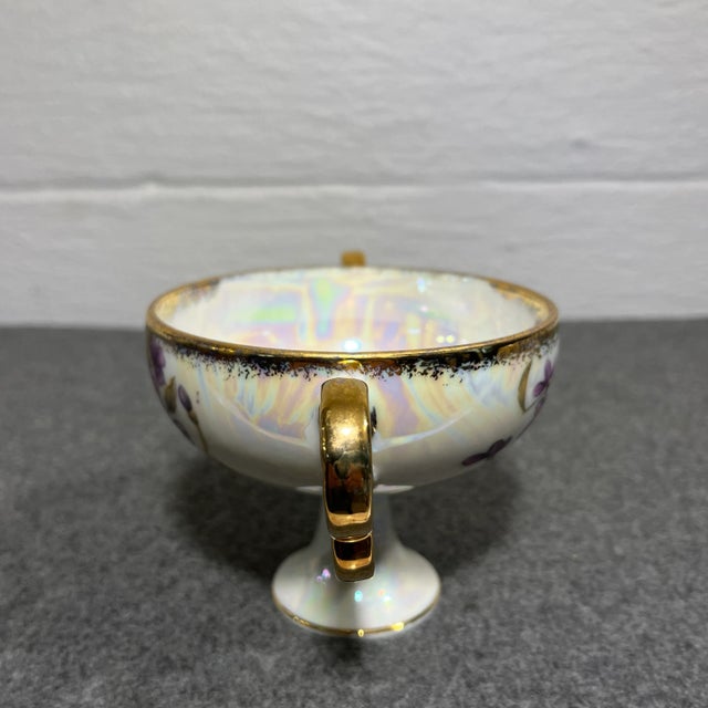 Handsome piece of China by Royal Sealy. Pedestal cup with a pearl colored Lusterware glaze and purple florals trimmed with...