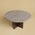 The Tinian is a Titanium travertine and oak coffee table, a low table for the space in front of a sofa in which a...