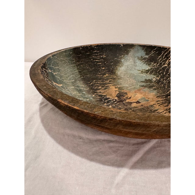 Elevate your decor with this striking 14” hand-turned wooden bowl featuring a richly distressed interior in worn black...