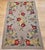 28” x 45” Vintage American hand hooked area rug in a fruit pattern circa the early 20th century. The very unique and...