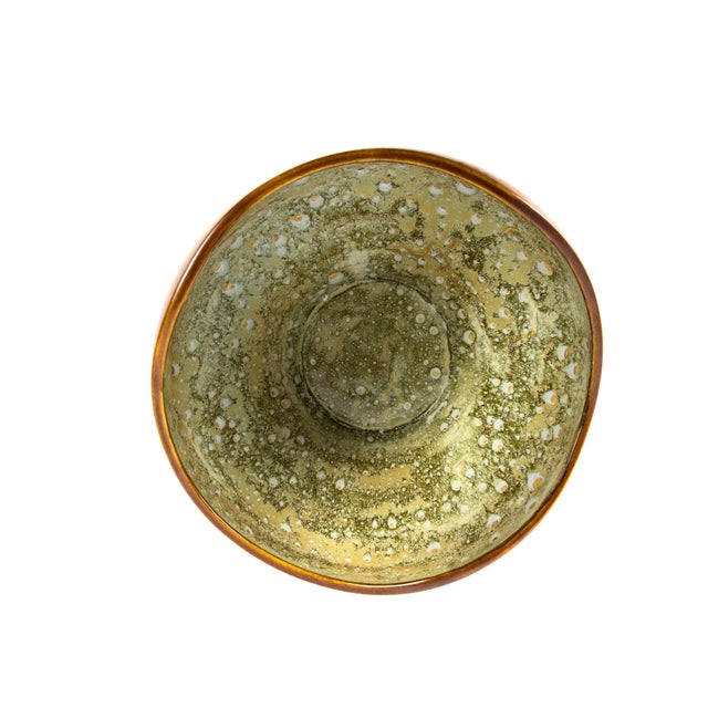 A large and visually striking French art pottery bowl attributed to the Faïencerie de Pierrefonds, showcasing a richly...