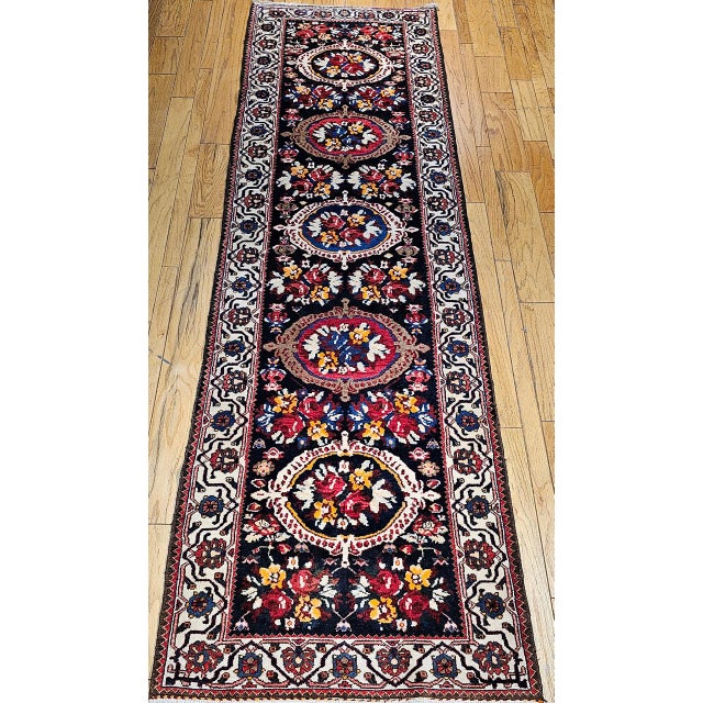 "This vintage Persian Bakhtiari wide runner, handwoven in the early 20th century, is a beautiful expression of tribal...