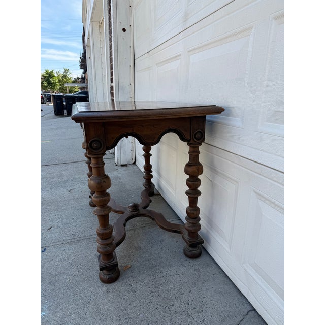 We have an absolutely stunning vintage Jacobean Revival console table for sale. It features beautifully turned legs, a...