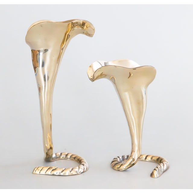 A fine pair of polished solid brass calla lily shaped candlesticks candle holders. These stylish candle holders have a...