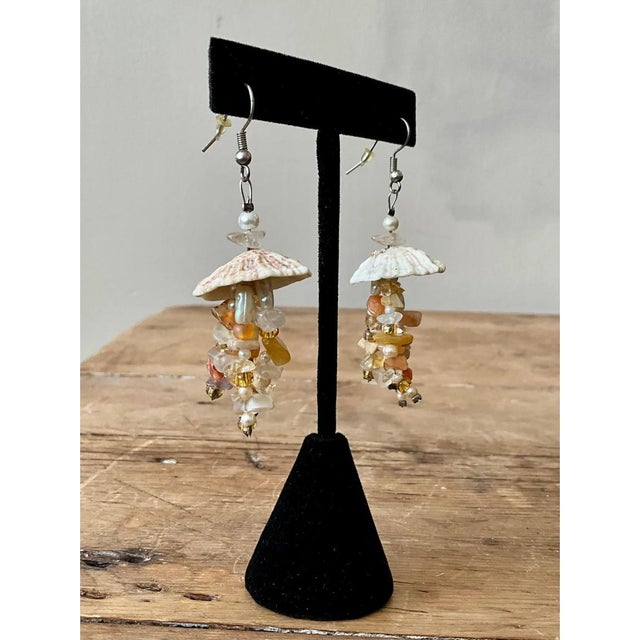 These vintage drop earrings are whimsical, jellyfish-like creations that hang from silver-tone French wire hooks fitted...