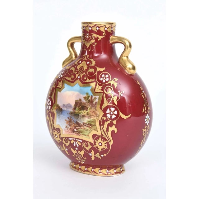 A charming vase by the storied English firm of Coalport. This sweetie features 2 handles, and an interesting hand painted...