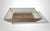 An elegant and refined basket featuring a structure composed of lacquered brass slats that frame a clear lucite panel,...