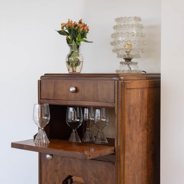 Incredible Art Deco bar cabinet from France, 1930s. Beautiful walnut with bookmatched pattern. Lift-top lid with drop...