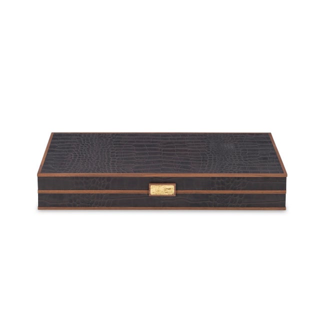 Dark brown croc leather backgammon game board with walnut trim and a cast brass handle. Interior is crafted of inlaid...