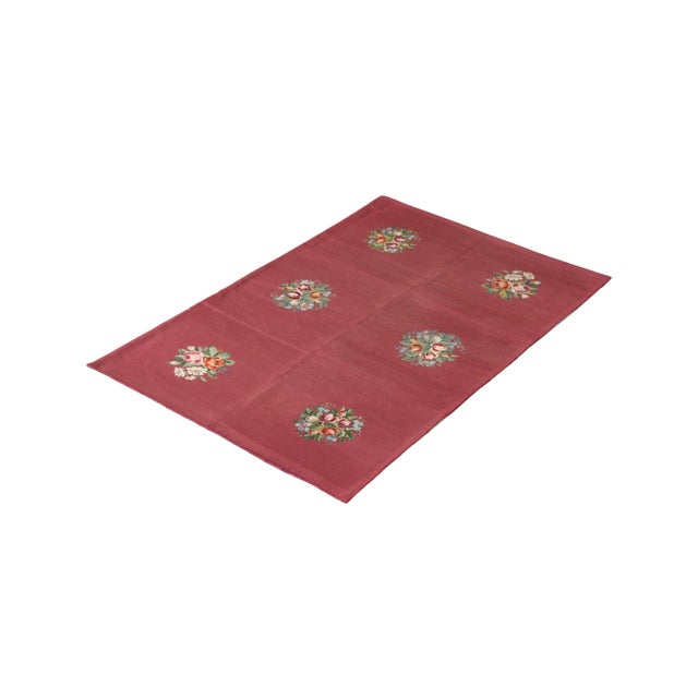 Handmade in wool originating from England circa 1910-1920, this antique rug connotes an early 20th Century needlepoint rug...