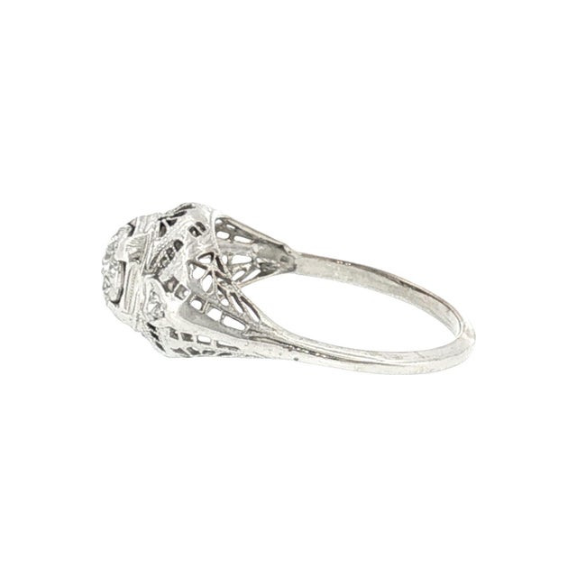 A 1930's 14k gold cluster ring featuring a central arrangement of 7 old mine-cut diamonds. The design highlights a cluster...