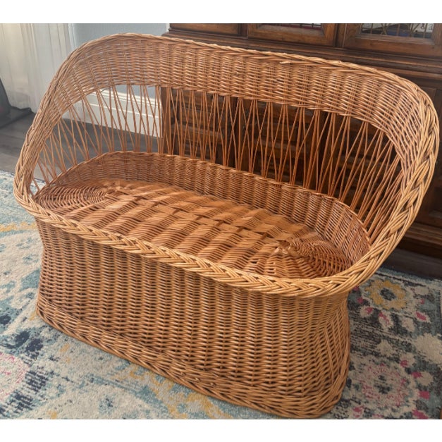 Beautiful vintage wicker rattan loveseat with a warm natural tone and timeless coastal boho style. This piece features an...