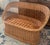 Beautiful vintage wicker rattan loveseat with a warm natural tone and timeless coastal boho style. This piece features an...