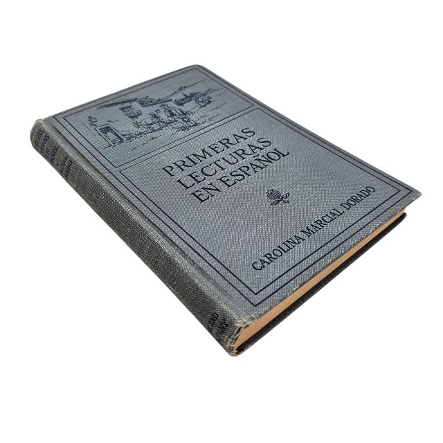 A 1920s instructional reader titled Primeras Lecturas en Español, authored by Carolina Marcial Dorado and published by...