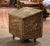 Crafted in France, circa 1920, the antique wood and brass fireplace wood coffer stands on coasters; the trunk is decorated...