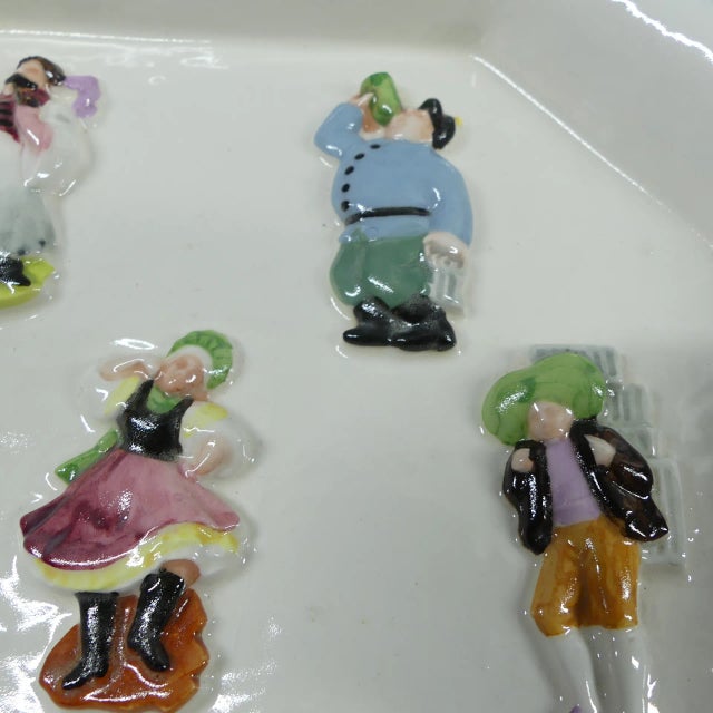 Art Deco bowl or plate in an octagonal form with genre figures in relief 16.8 x 16.8 cm, edge height 2.5 cm This piece has...