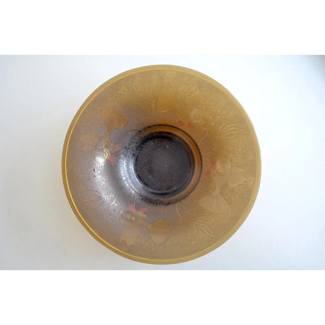 Amber -colored glass bowl from the time of Art Deco from the Bohemian area. The glass shell has colored a surrounding...