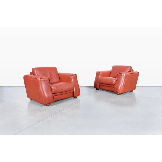 Vintage leather lounge chairs designed by Formenti in Italy during the 1980s. Upholstered in rich, thick Italian leather,...