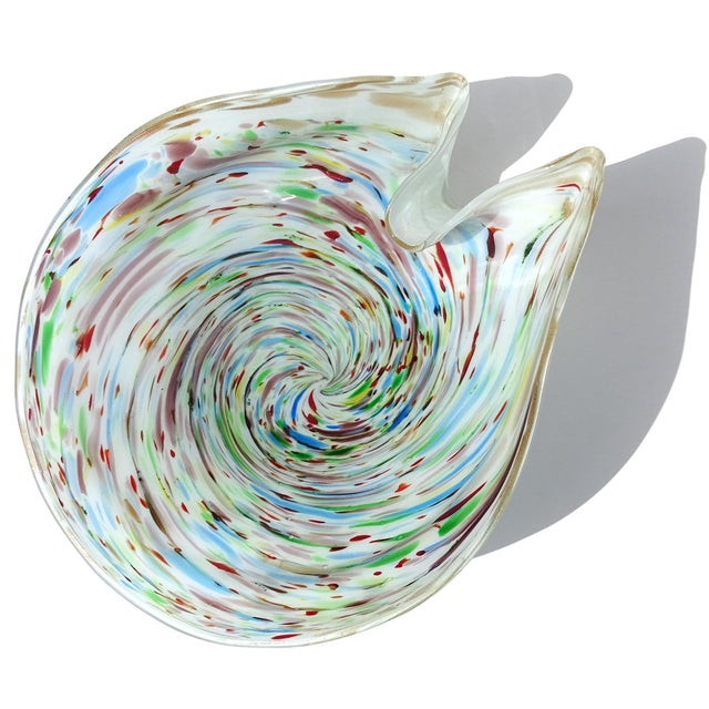 Beautiful vintage Murano hand blown white, with a rainbow swirl design Italian art glass decorative bowl. The piece has a...