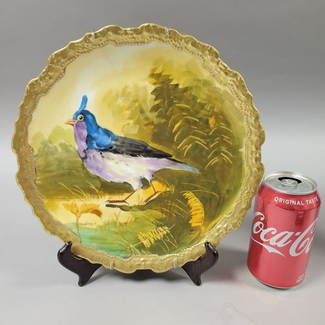 A fantastic French Limoges hand painted porcelain game bird decorative plate with gold gilt border. The painting depicts a...
