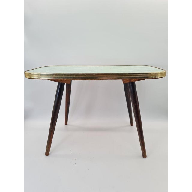An original mid-century modern coffee table, made in Europe in the 1960s. Its simple, timeless form is combined with a...