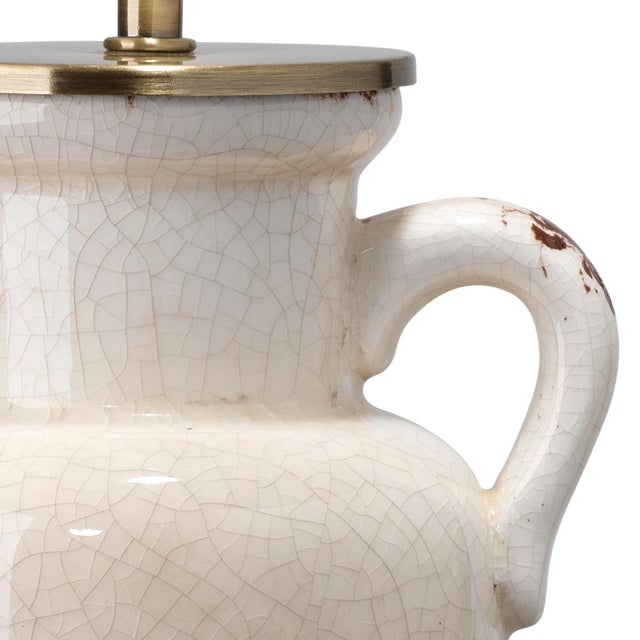 Expert antiquing lends this ceramic lamp the look of a vintage treasure. The base and coordinating ball finial are...