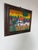 A vibrant 2003 folk art oil on canvas painting by Jadiro, depicting a lively village scene surrounded by lush tropical...