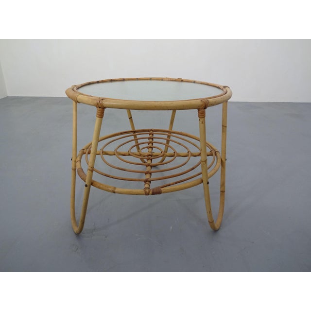 Small bamboo table with a glass top.