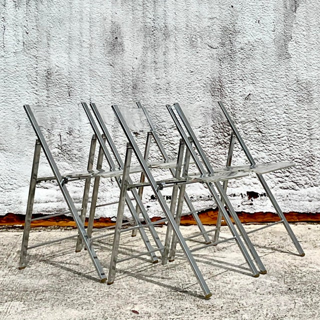 Add a retro touch to your decor with these Vintage Boho Chrome and Metal Folding Chairs. Featuring a sleek chrome frame...