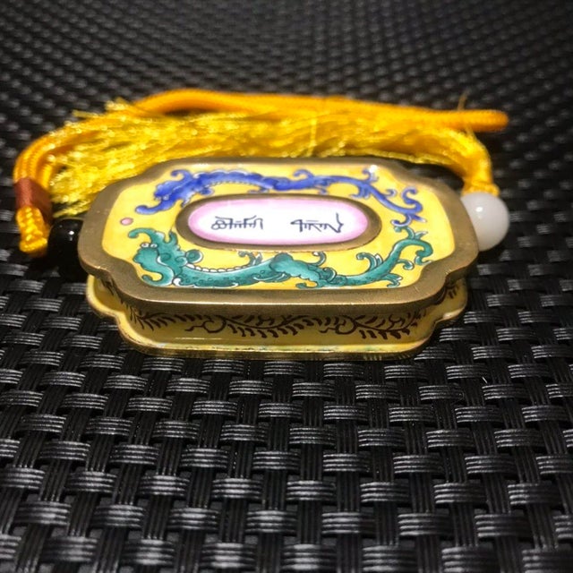 This is a small, exquisitely crafted vintage pendant or amulet, made using the traditional cloisonné enamel technique on a...