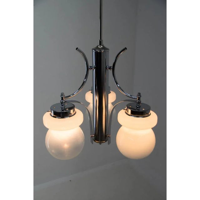 Three-flamming chandelier made of steel and blown glass attributed to Murano glass. Polished, rewired: 3x40W, E12-E14...