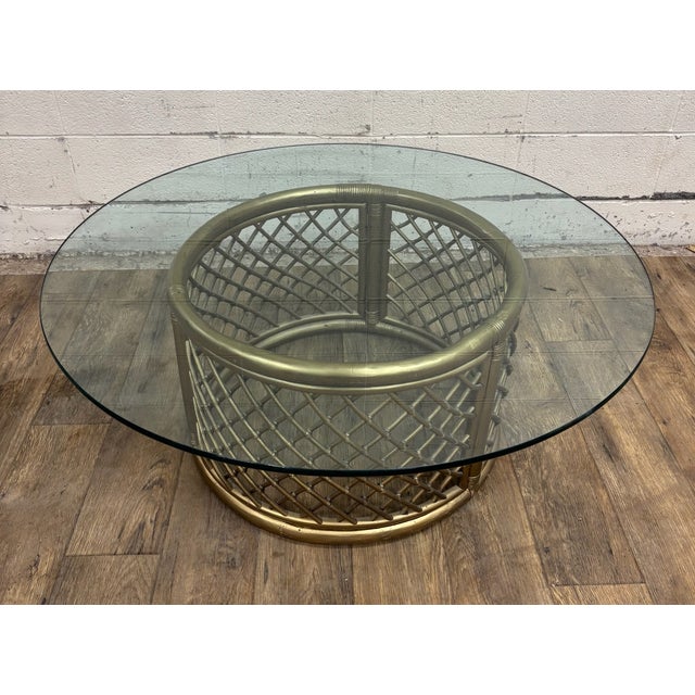 This is an absolutely beautiful vintage Boho style rattan and glass round coffee table or cocktail table. Rattan is gold...