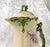This is a cream color matte finish Jean Pouyat Limoges chocolate pot with a matching lid. It has a light and dark green...
