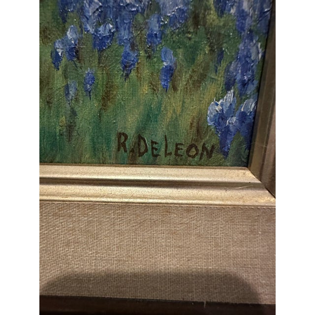 16x20 framed oil painting of the blue bonnets in the Texas hill country. Signed in the lower right corner R. DeLeon. A...