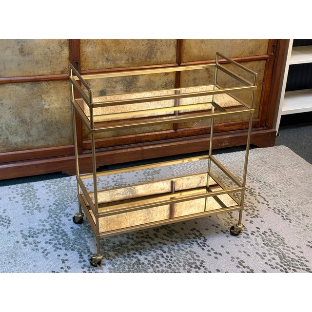Design Plus Gallery presents a Metal Bar Cart with Mirrored Shelves. The bar cart is a great staple in your home as it is...