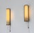 A pair of Art Deco glass and metal wall lamps. These lamps are ideal for various areas of the home, from the entryway to...