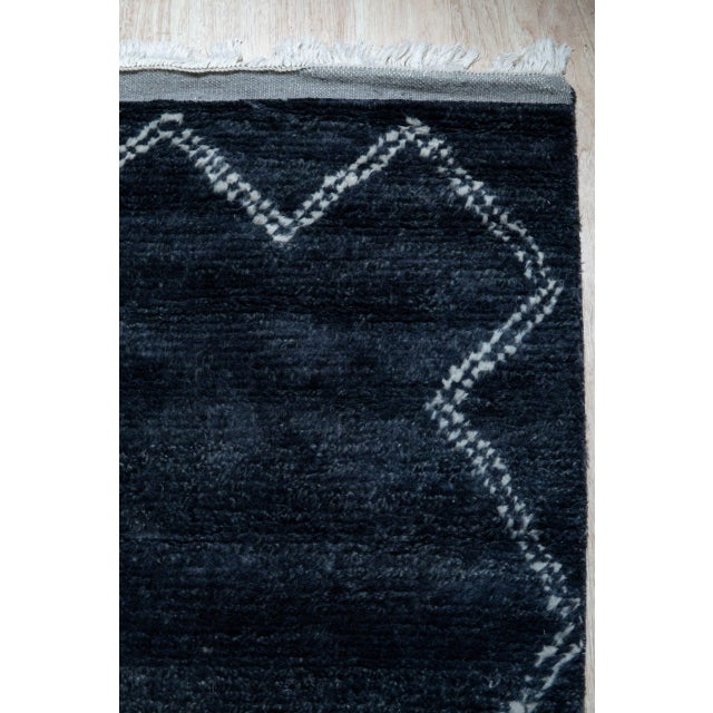 Talia Moroccan Charcoal Hand Knotted Wool Rug, Country of Origin: India. This exceptional piece blends the primal...