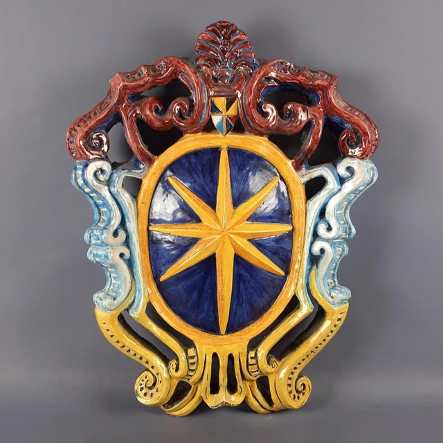 An impressive and extremely rare large decorative wall coat of arms, crafted from heavy, solid polychrome majolica and...