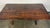 A beautifully worn, handcrafted trestle dining table with timeless rustic appeal, dating to the mid-20th century. The...