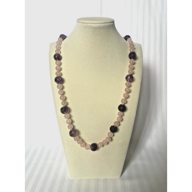 Rose Quartz and Amethyst Beaded Necklace. The necklace is crafted with rose quartz and hand carved amethyst beads. Hand...
