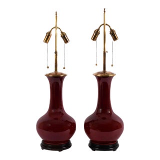 Pair of Mid-Century Oxblood Sang De Boeuf Chinese Porcelain Vase Lamps With Brass Double Sockets, Circa 1950s For Sale