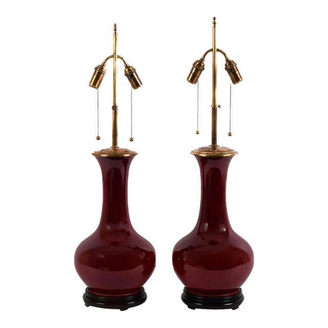 Pair of Mid-Century Oxblood Sang De Boeuf Chinese Porcelain Vase Lamps With Brass Double Sockets, Circa 1950s For Sale