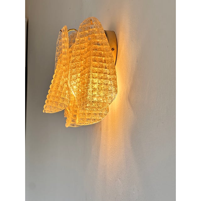 Scenographic and luxury Murano glass wall sconces “Rondini” elements in Murano glass poured over a mold from a traditional...