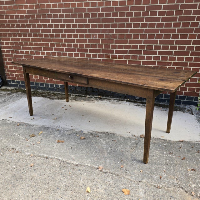 A very good antique oak three plank French farmhouse kitchen refrectoy dining table with a central drawer, slim tapering...