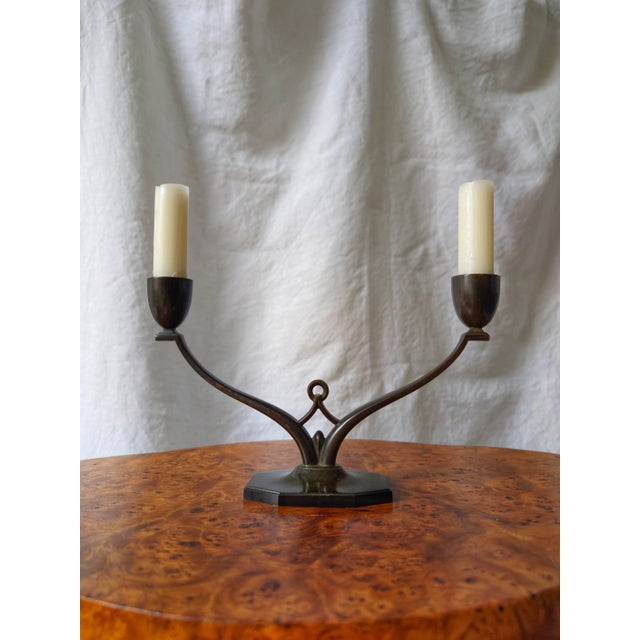 A rare bronze candelabra by the danish metalware artisan just andersen. This covetable mid century modern candleholder was...